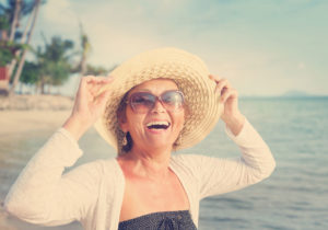 woman smiles with Teeth-in-a-Day dental implants Westerly RI New London CT